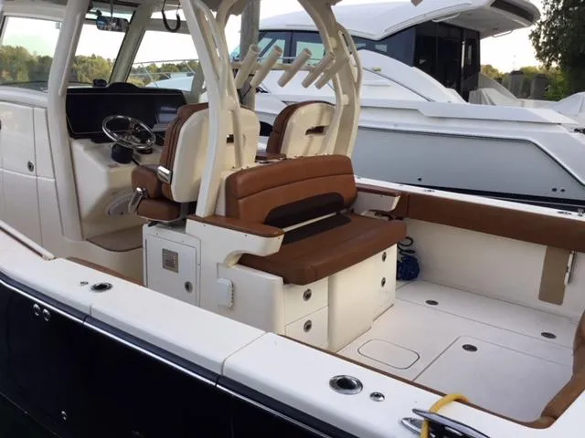 Slide: The Image of 2016 Scout 350 LXF boat interior with brown seating and modern helm. - 8