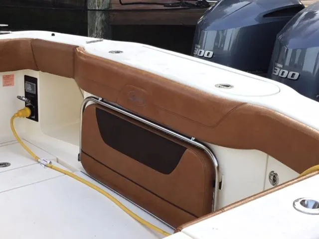 Slide: The Image of 2016 Scout 350 LXF boat interior with brown seating and dual 300 horsepower engines. - 9