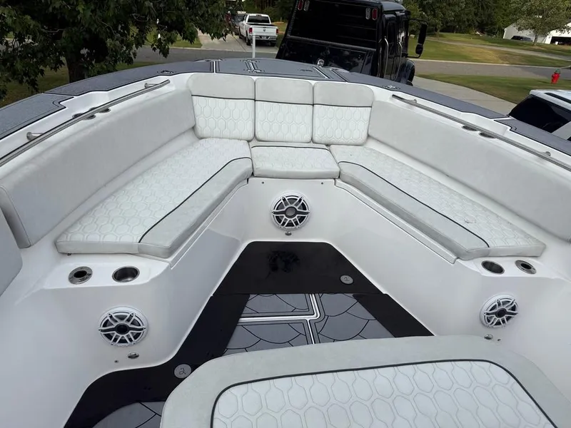 Slide: The Image of 2022 Sea Fox 328 Commander boat interior with cushioned seating and cup holders. - 11