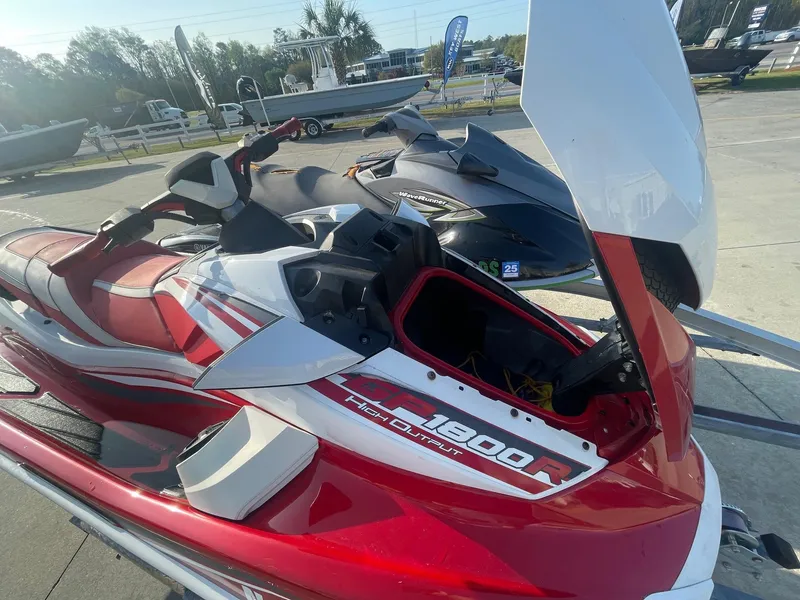 Slide: The Image of 2021 Yamaha WaveRunner GP1800R HO in red and white, parked outdoors. - 14