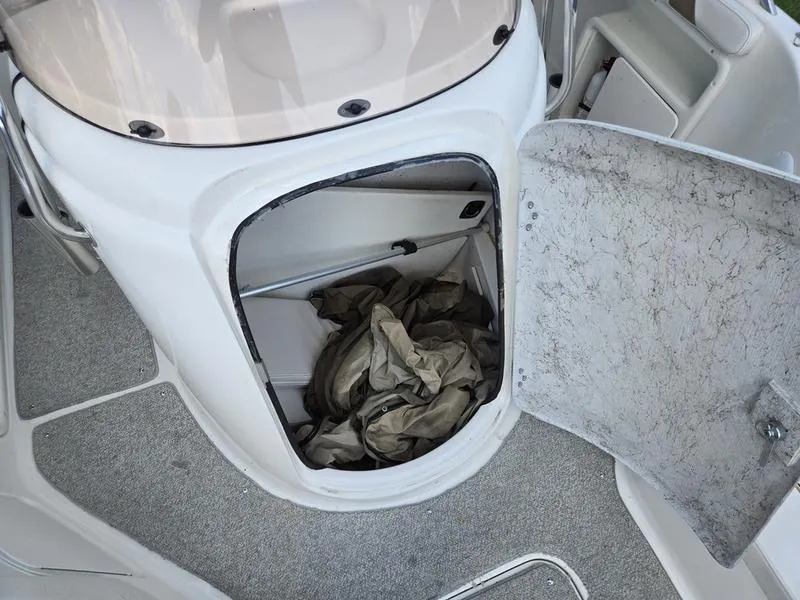Slide: The Image of Open storage compartment on 2006 Hurricane GS 211 OB Fun Deck boat. - 13