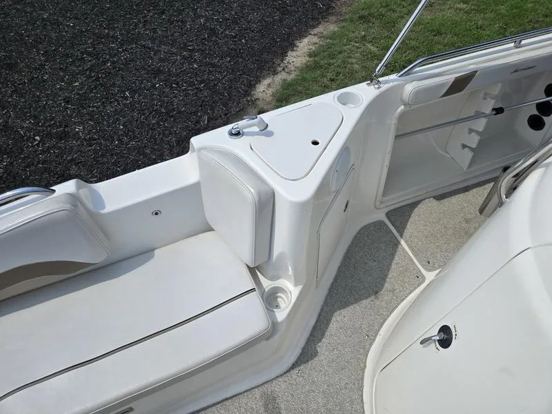Slide: The Image of 2006 Hurricane GS 211 OB Fun Deck interior with seating and storage compartments. - 14