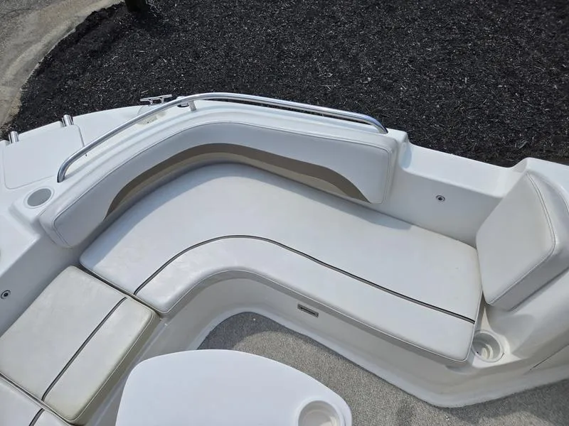 Slide: The Image of 2006 Hurricane GS 211 OB Fun Deck boat interior with white cushioned seating. - 16