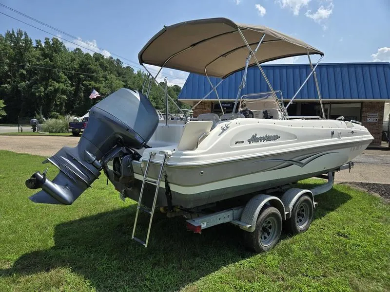 Slide: The Image of 2006 Hurricane GS 211 OB Fun Deck boat on trailer, parked on grass. - 5