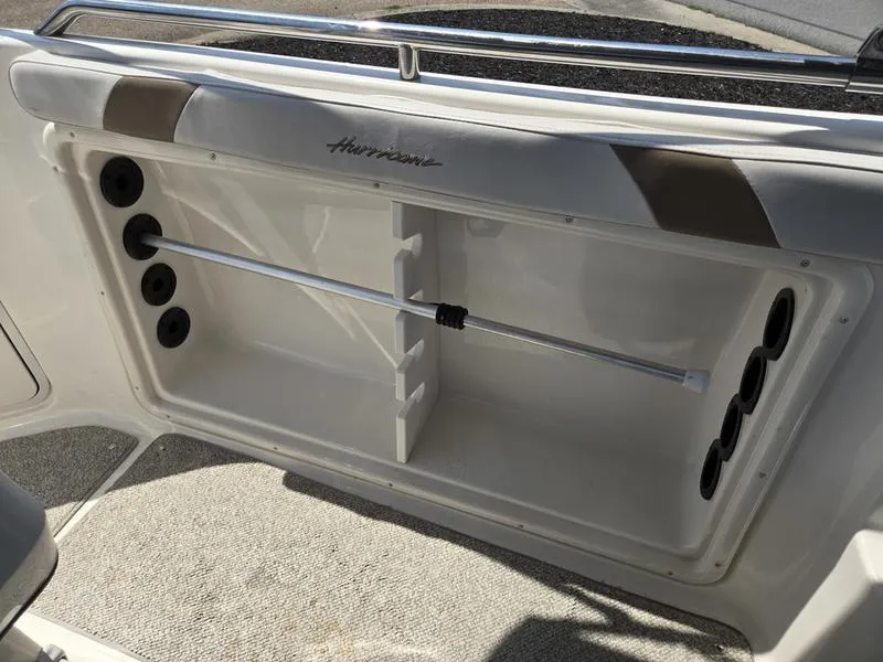 Slide: The Image of 2006 Hurricane GS 211 OB Fun Deck storage compartment with rod holders and cushioned seating. - 7