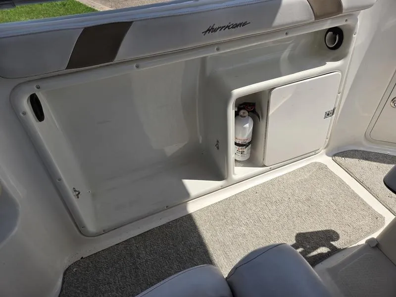 Slide: The Image of Interior of a 2006 Hurricane GS 211 OB Fun Deck boat, featuring storage compartments. - 8