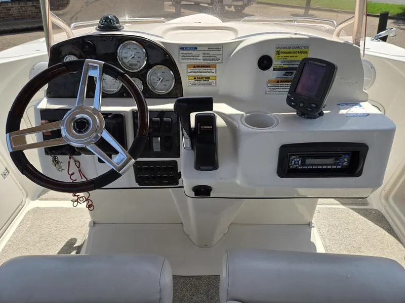 Slide: The Image of 2006 Hurricane GS 211 OB Fun Deck boat dashboard with steering wheel and controls. - 9