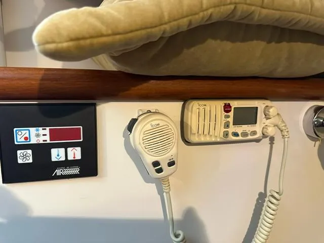 Slide: The Image of Control panel and radio equipment inside a 2003 Pursuit 3070 Express boat cabin. - 10