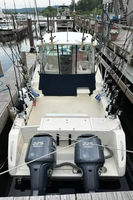 Slide: The Image of 2003 Pursuit 3070 Express boat with twin 225 engines docked at marina. - 11