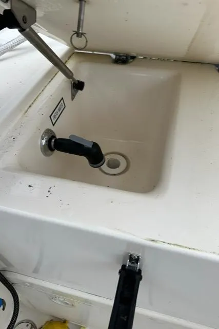 Slide: The Image of 2003 Pursuit 3070 Express boat sink with faucet and drain. - 18