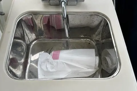 Slide: The Image of Stainless steel sink with faucet on 2003 Pursuit 3070 Express boat. - 19