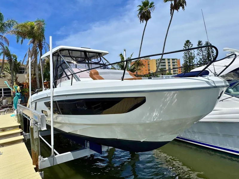 The Image of 2022 Beneteau Flyer 9 SUNdeck boat docked near palm trees and buildings. - 0