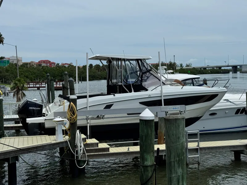 Slide: The Image of 2022 Beneteau Flyer 9 SUNdeck docked at marina with Mercury outboard engine. - 1