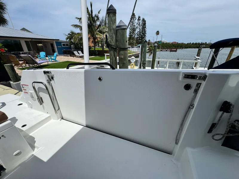 Slide: The Image of 2022 Beneteau Flyer 9 SUNdeck boat docked near waterfront with palm trees. - 10