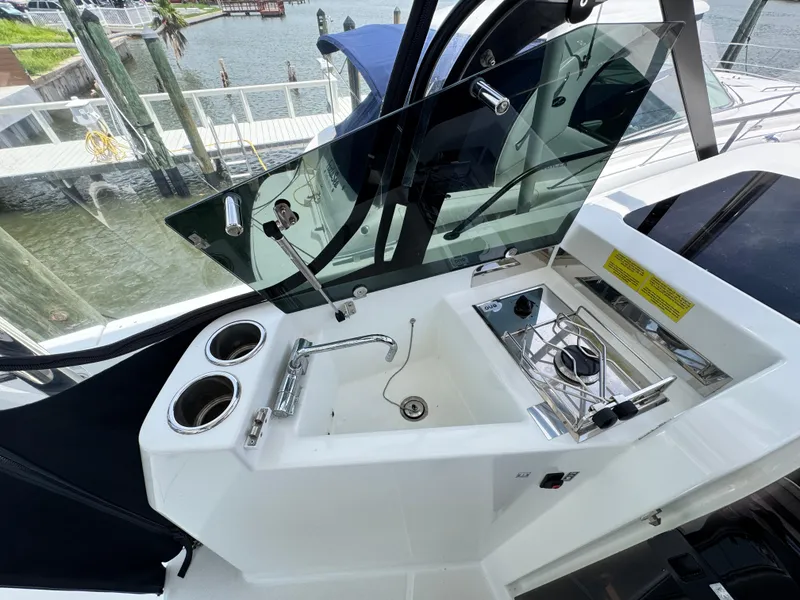 Slide: The Image of 2022 Beneteau Flyer 9 SUNdeck boat kitchen area with sink and stove. - 12