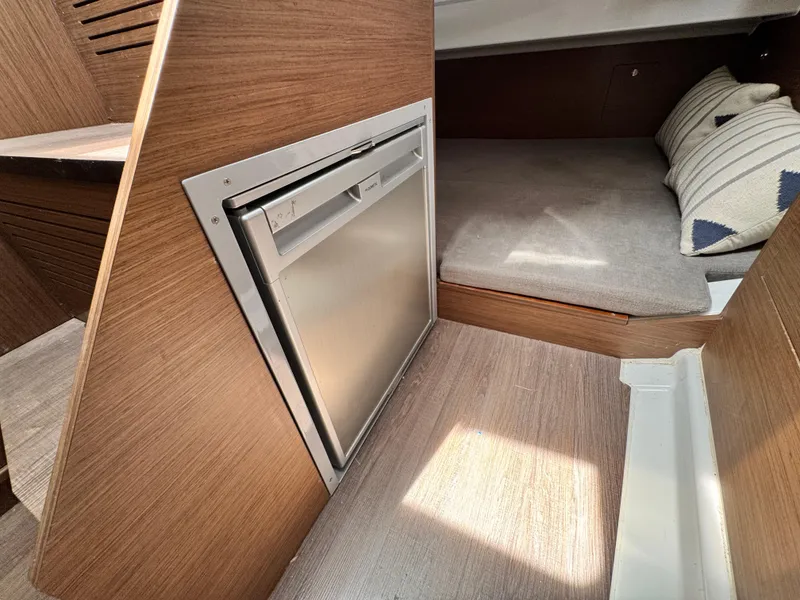 Slide: The Image of Interior of 2022 Beneteau Flyer 9 SUNdeck with compact fridge and cozy sleeping area. - 25