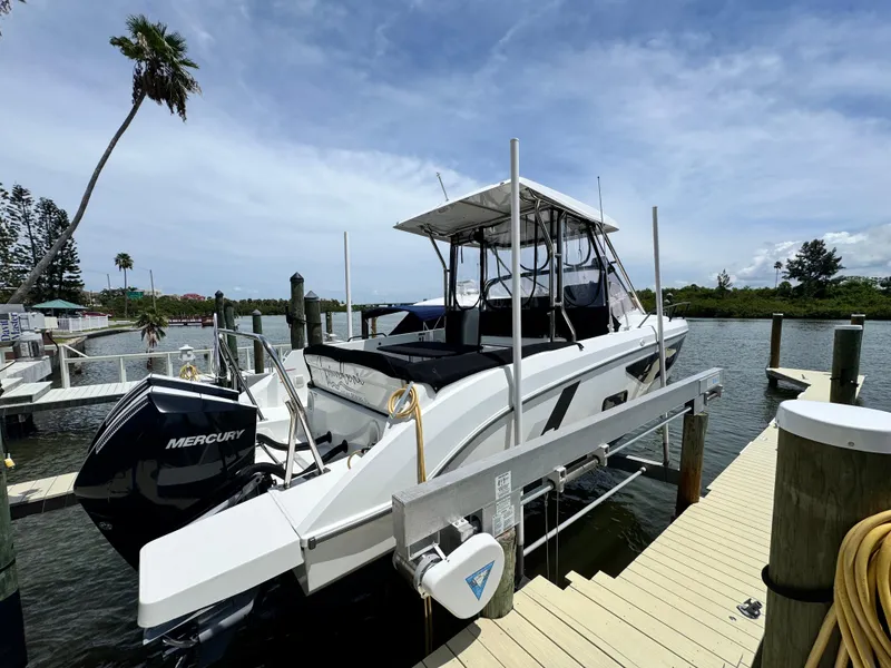 Slide: The Image of 2022 Beneteau Flyer 9 SUNdeck docked, featuring a Mercury engine, under a clear blue sky. - 3