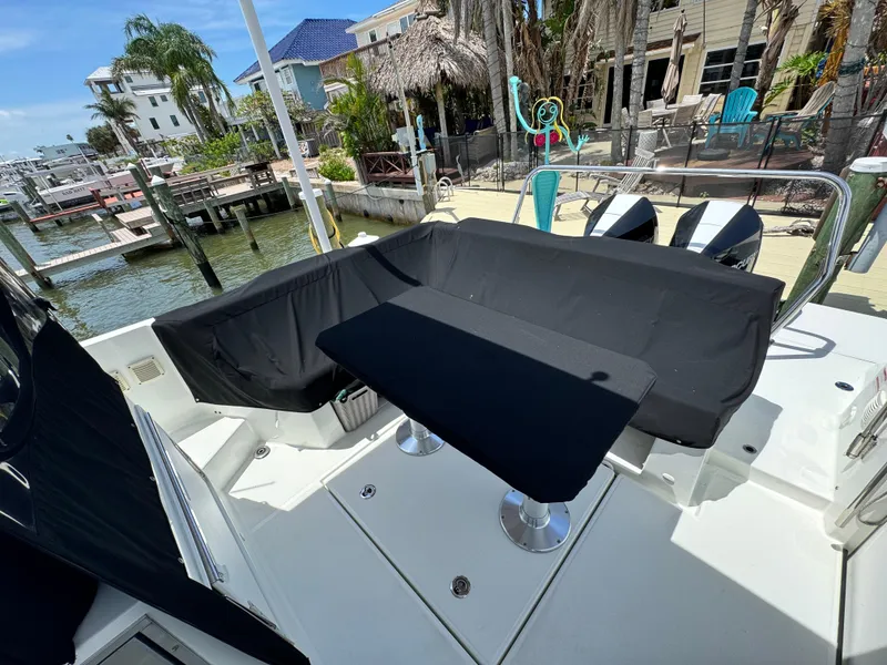 Slide: The Image of 2022 Beneteau Flyer 9 SUNdeck boat with covered seating area at a dockside location. - 31