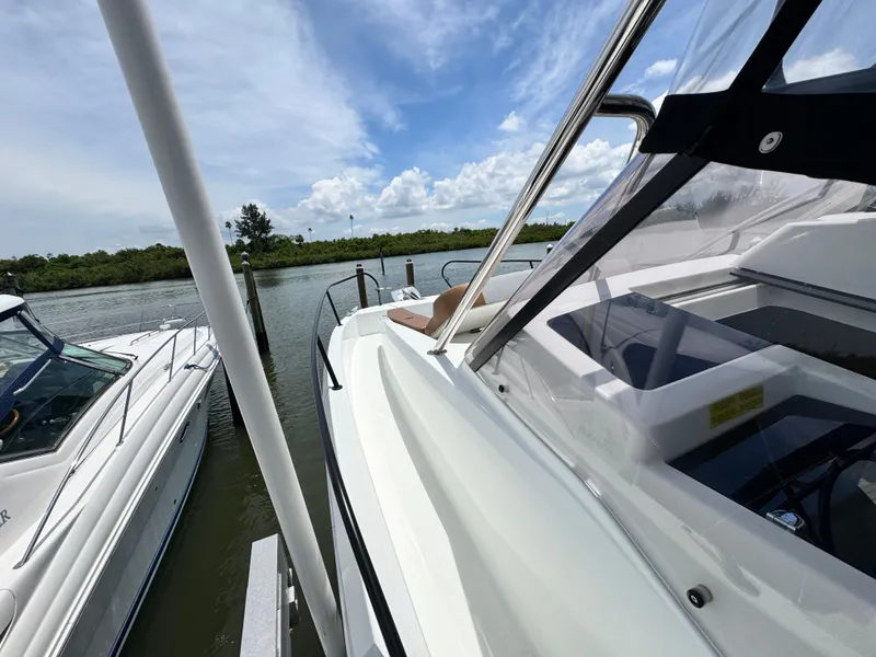 Slide: The Image of 2022 Beneteau Flyer 9 SUNdeck docked beside another boat on a sunny day. - 34