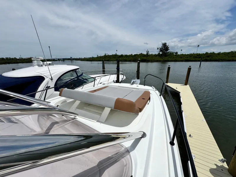 Slide: The Image of 2022 Beneteau Flyer 9 SUNdeck moored at a dock, under a partly cloudy sky. - 36