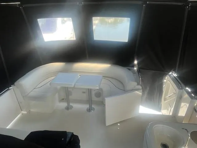 Slide: The Image of 2000 Cruisers Yachts 4450 Express Motoryacht interior with seating and tables. - 12