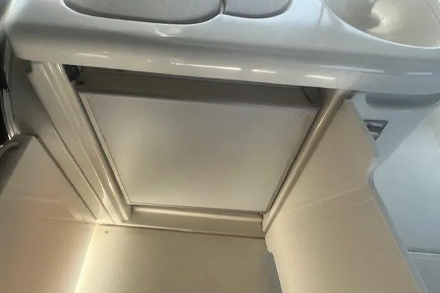 Slide: The Image of Interior view of 2000 Cruisers Yachts 4450 Express Motoryacht, featuring a compact storage area. - 16