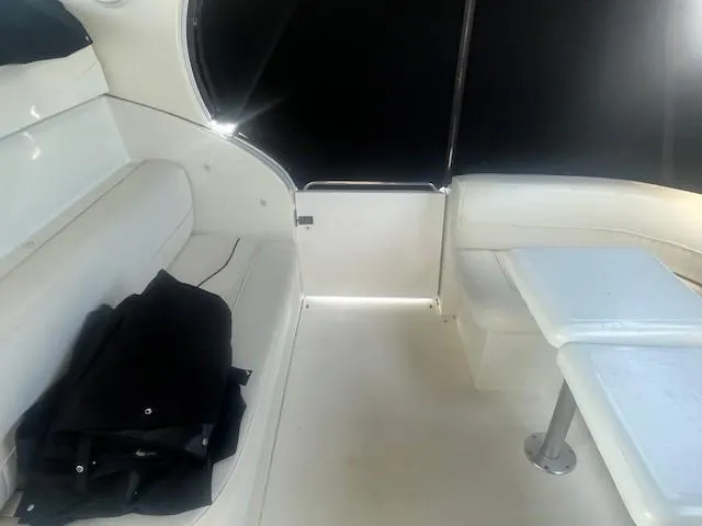 Slide: The Image of Interior of 2000 Cruisers Yachts 4450 Express Motoryacht with white seating and table. - 17