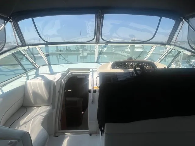 Slide: The Image of Interior view of 2000 Cruisers Yachts 4450 Express Motoryacht cockpit with helm and seating. - 18