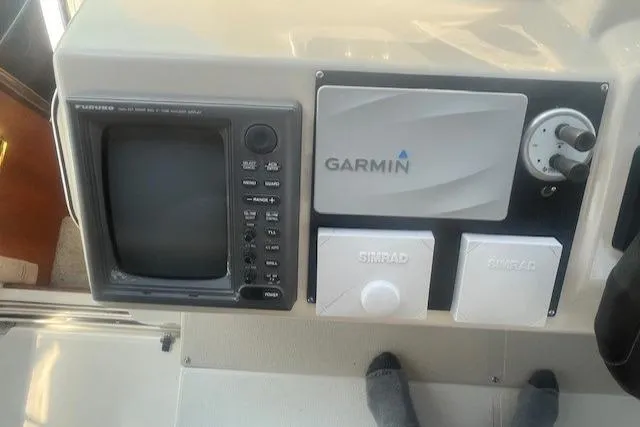 Slide: The Image of Control panel of 2000 Cruisers Yachts 4450 Express Motoryacht with Garmin and Simrad equipment. - 24