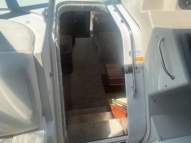 Slide: The Image of 2000 Cruisers Yachts 4450 Express Motoryacht interior view with stairs and seating area. - 25