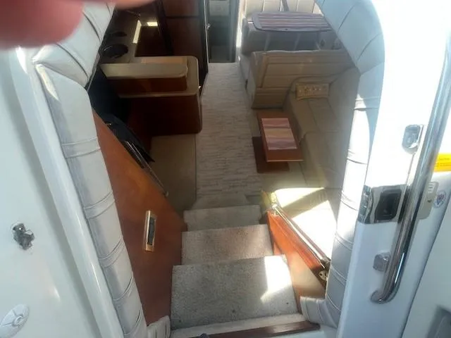 Slide: The Image of Interior view of 2000 Cruisers Yachts 4450 Express Motoryacht, featuring stairs and seating area. - 26