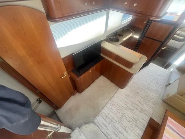 Slide: The Image of Interior of 2000 Cruisers Yachts 4450 Express Motoryacht with wood cabinetry and modern amenities. - 28