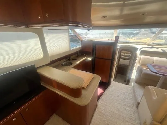 Slide: The Image of Interior of 2000 Cruisers Yachts 4450 Express Motoryacht with kitchen and seating area. - 29