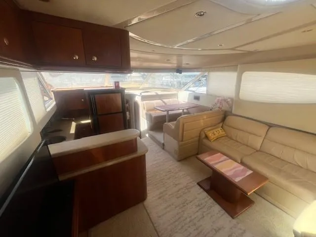 Slide: The Image of Luxurious interior of 2000 Cruisers Yachts 4450 Express Motoryacht with elegant seating and kitchen area. - 30