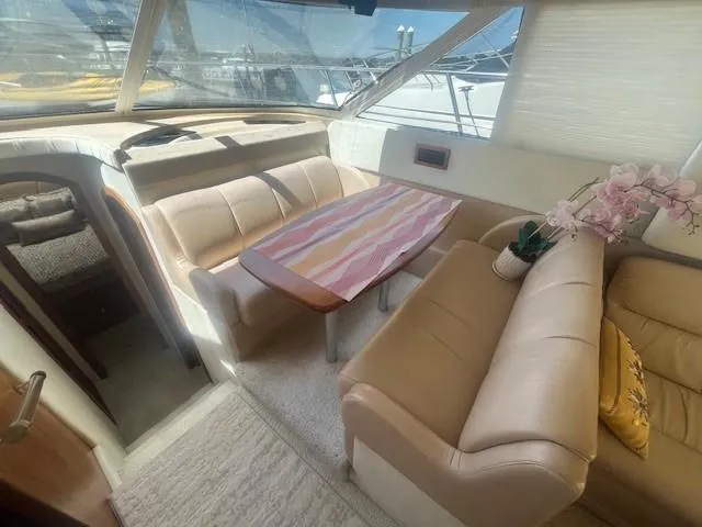 Slide: The Image of Luxurious interior of 2000 Cruisers Yachts 4450 Express Motoryacht with plush seating and table. - 31