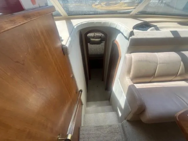 Slide: The Image of Interior view of 2000 Cruisers Yachts 4450 Express Motoryacht, showing stairs and seating area. - 35