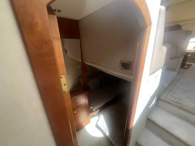 Slide: The Image of Interior cabin of 2000 Cruisers Yachts 4450 Express Motoryacht, featuring cozy sleeping area. - 39