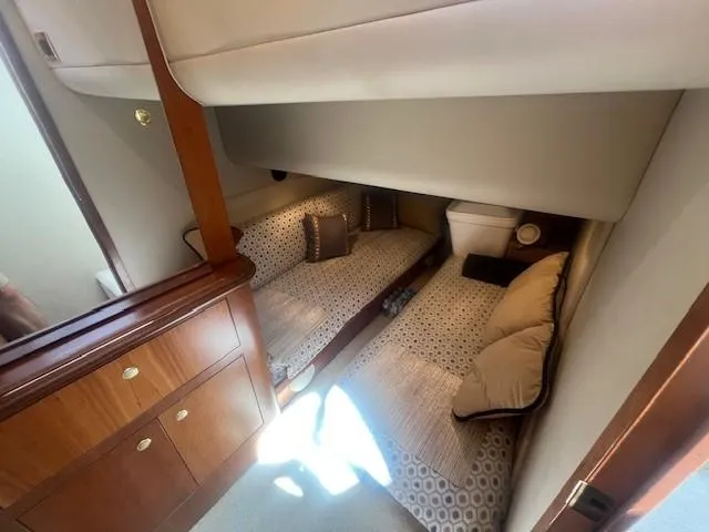 Slide: The Image of Interior cabin of 2000 Cruisers Yachts 4450 Express Motoryacht with twin beds and wooden cabinetry. - 40