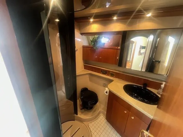 Slide: The Image of Luxurious bathroom in 2000 Cruisers Yachts 4450 Express Motoryacht with modern fixtures. - 44