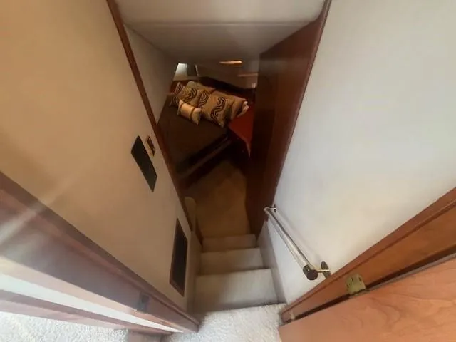 Slide: The Image of Stairway leading to cozy bedroom in 2000 Cruisers Yachts 4450 Express Motoryacht. - 47