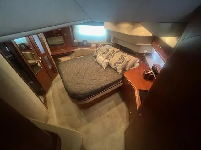 Slide: The Image of Luxurious bedroom in 2000 Cruisers Yachts 4450 Express Motoryacht with elegant wood finishes. - 48