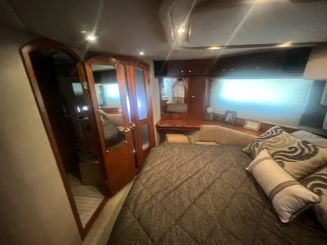 Slide: The Image of Luxurious bedroom interior of 2000 Cruisers Yachts 4450 Express Motoryacht with elegant wood finishes. - 49