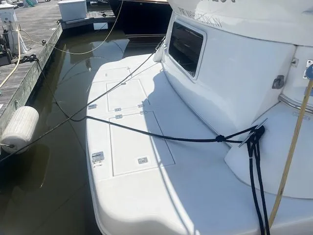 Slide: The Image of 2000 Cruisers Yachts 4450 Express Motoryacht docked at marina. - 7