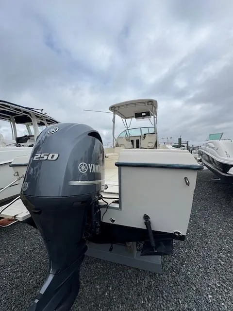 Slide: The Image of 1992 Grady-White Explorer 244 boat with Yamaha 250 outboard motor, docked on gravel. - 11
