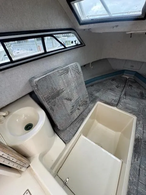 Slide: The Image of 1992 Grady-White Explorer 244 cabin interior with sink and storage compartment. - 15