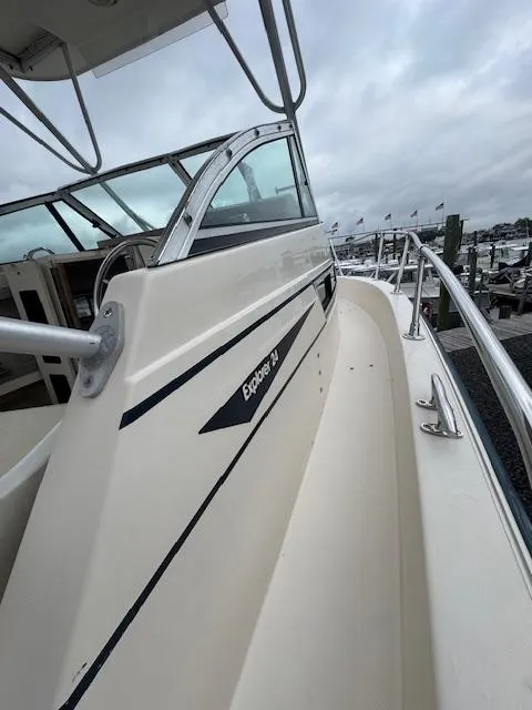 Slide: The Image of 1992 Grady-White Explorer 244 boat, side view, docked with overcast sky. - 18