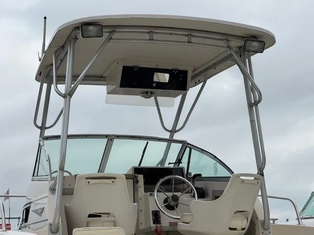 Slide: The Image of 1992 Grady-White Explorer 244 boat interior with steering wheel and seating. - 2
