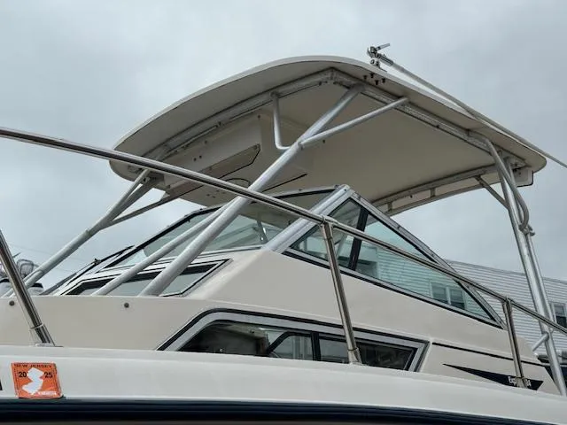 Slide: The Image of 1992 Grady-White Explorer 244 boat with a sturdy canopy and sleek design. - 20