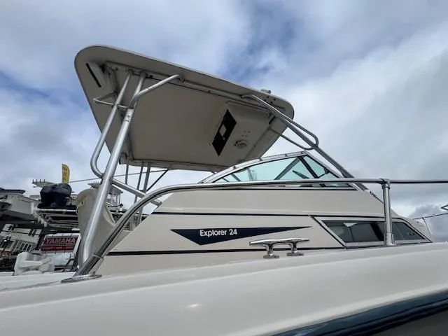 Slide: The Image of 1992 Grady-White Explorer 244 boat with T-top and railing, under cloudy sky. - 22