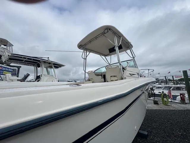 Slide: The Image of 1992 Grady-White Explorer 244 boat docked under cloudy skies. - 23
